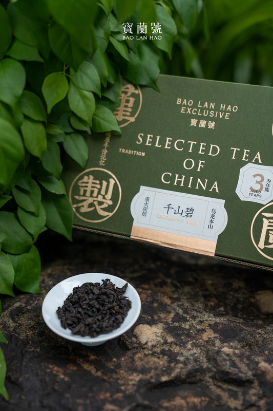 Green “Selected Tea of China” box with a bowl of dark loose tea